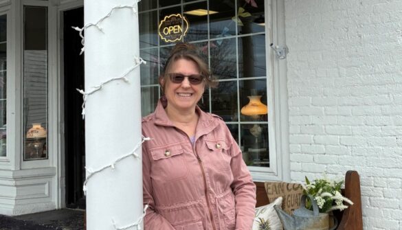 The Dexter Corner Shoppe Owner of Dexter Corner Shoppe in front of storefront.